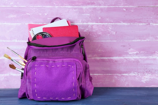 School backpack on wooden background