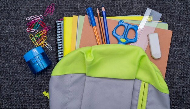 A school bag with school supplies for back to school concept