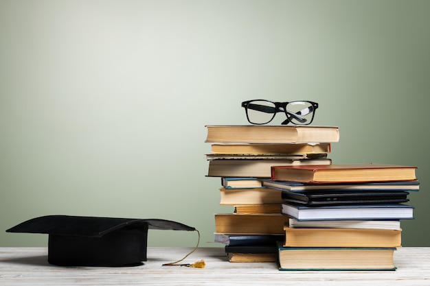 School blackboard with pile of books