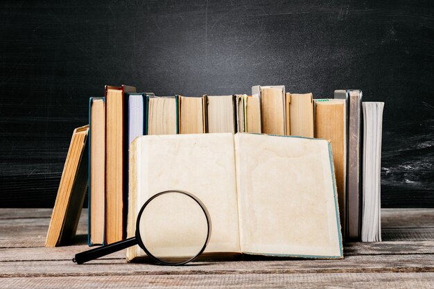 School blackboard with pile of books