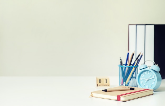 Photo school books on the desk at home, education learning concept.