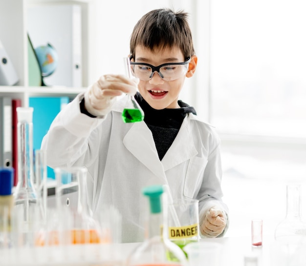 School boy in chemistry class