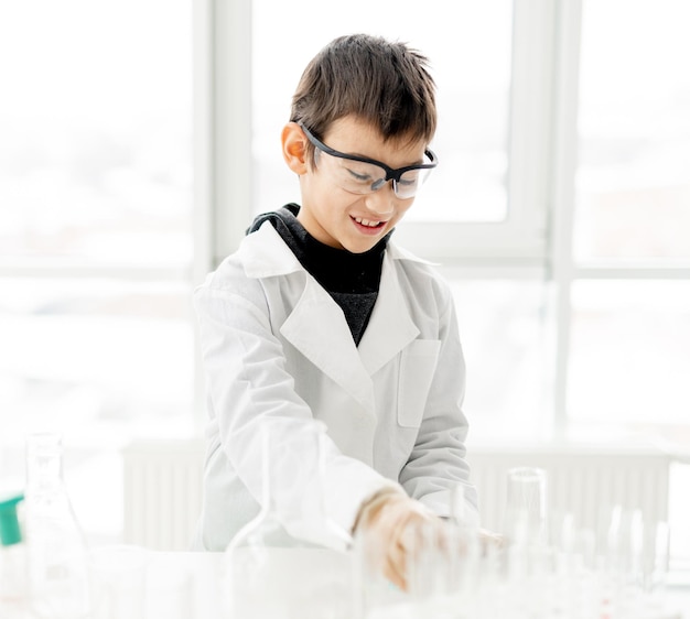 School boy in chemistry class