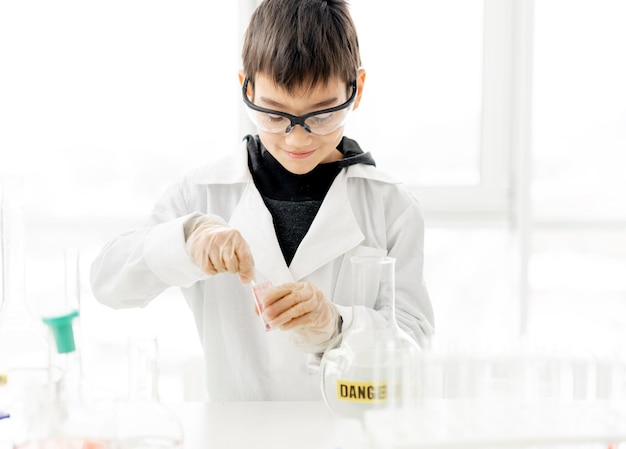 School boy in chemistry class