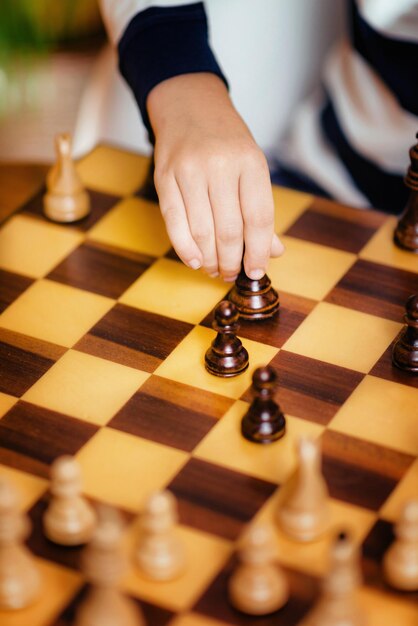 School boy playing chess