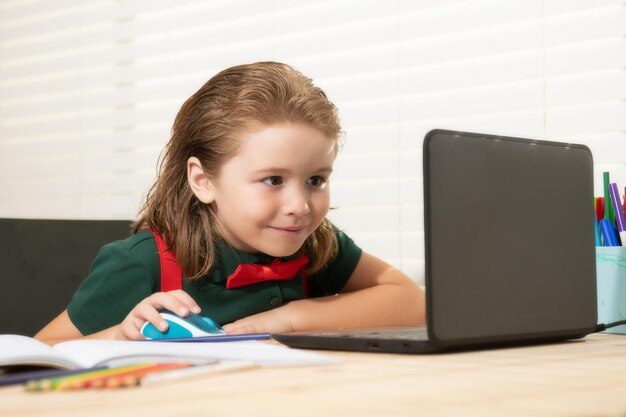 School boy pupil is studying online home schooling kids distance learning cute child using laptop ed