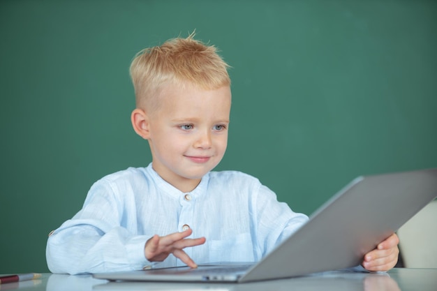 School boy studying math during online lesson in classroom online education Little funny programmer