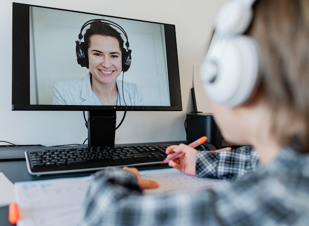 Photo school boy taking online courses with teacher