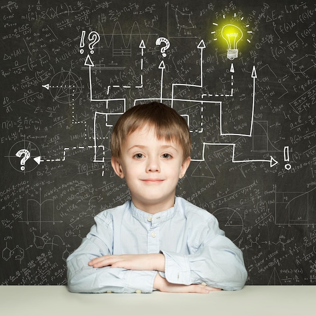 Photo school boy with question signs and light idea bulb education concept