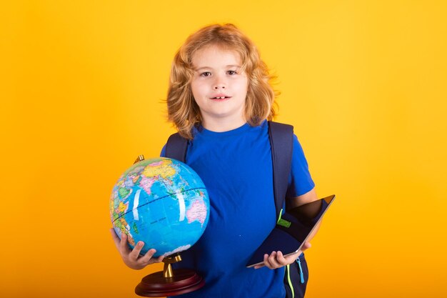 School boy world globe and tablet school child 78 years old with book go back to school little student