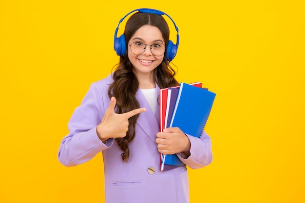 School child girl with headphones and book