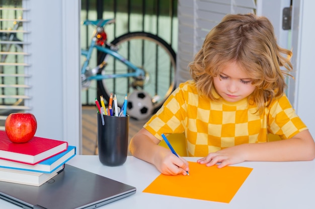 School child student learning at home writing school homework elementary school child doing homework