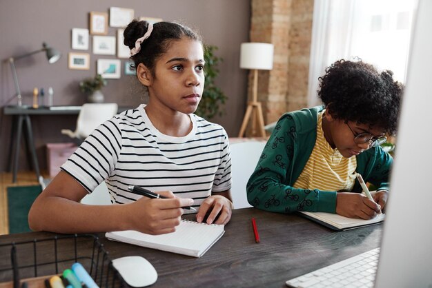 School children studying online on computer