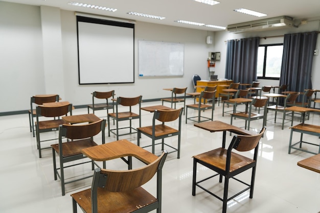 School classroom with many wooden chairs wellarranged in rows
with no student