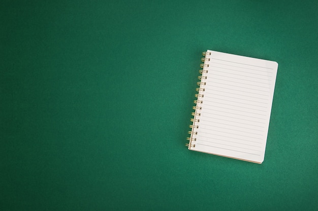 School clear notebook on a green background.