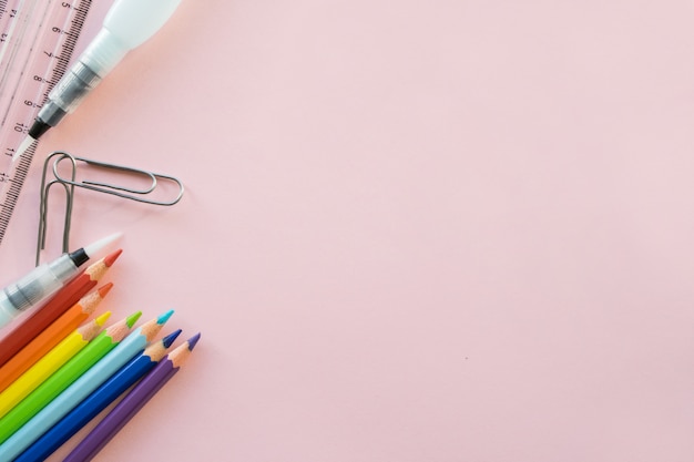 School drawing supplies on pink background. copyspace