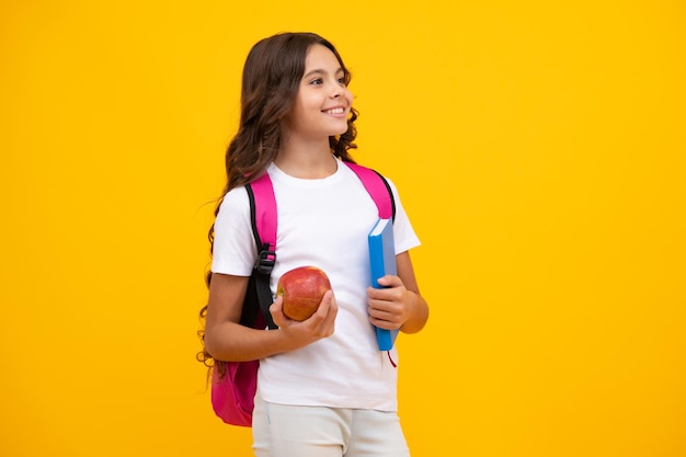 School and education concept back to school schoolchild teenage student girl with bagpack hold apple