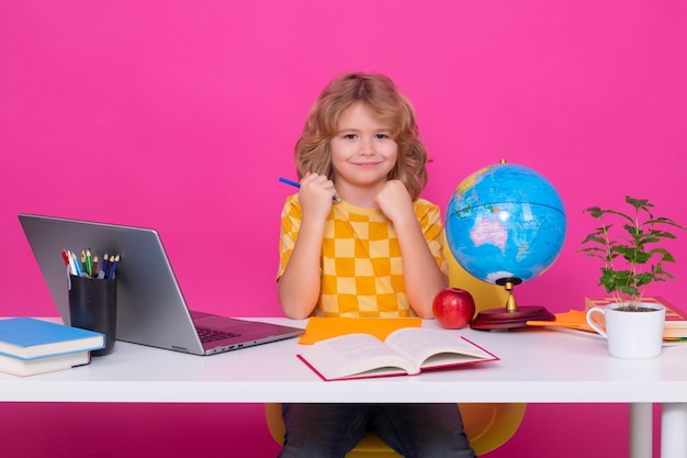 School and education concept Portrait of cute child school boy isolated on pink red studio background Back to school