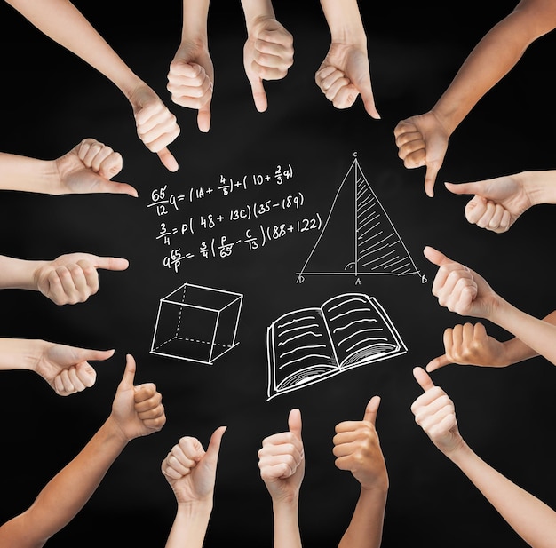 school, education, gesture, mathematics and people concept - human hands showing thumbs up in circle over black board background with mathematical symbols