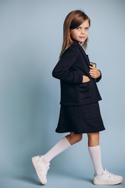 School girl in uniform holding books