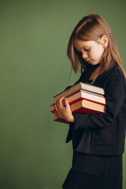 School girl in uniform holding books