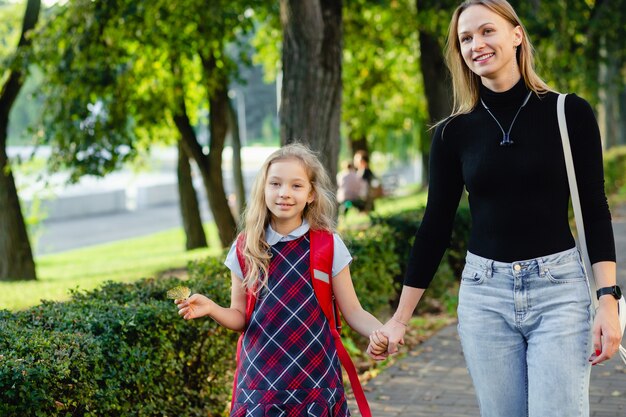 School girl walking with her mother