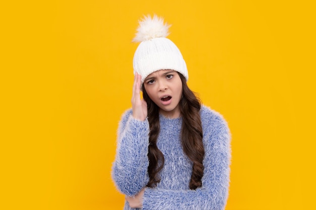 School girl in winter clothes and warm hat Winter holiday vacation Child fashion model Angry teenager girl upset and unhappy negative emotion