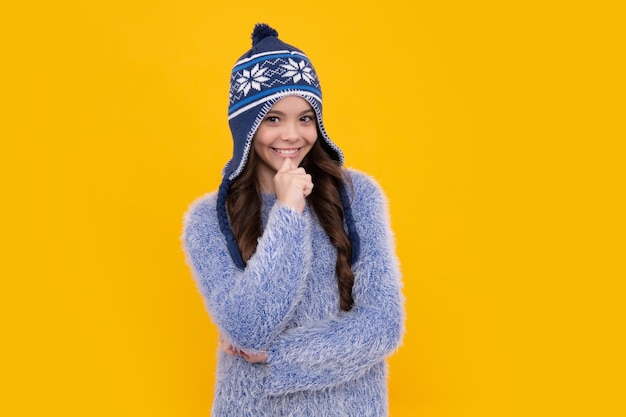 School girl in winter clothes and warm hat Winter holiday vacation Child fashion model Happy face positive and smiling emotions of teenager girl