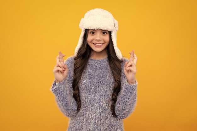 School girl in winter clothes and warm hat winter holiday vacation child fashion model happy teenager positive and smiling emotions of teen girl