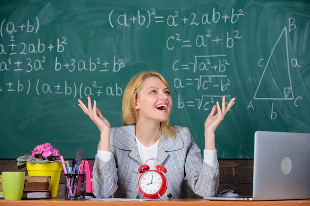 School Home schooling happy woman teacher with clock at blackboard Back to school Teachers day woman in classroom Study and education Modern school Knowledge day Business professionals