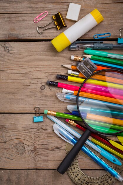 School items on a wooden table, Pencils and student pens on a wooden surface