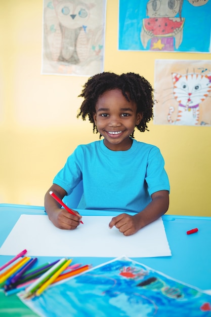 School kid drawing on a sheet