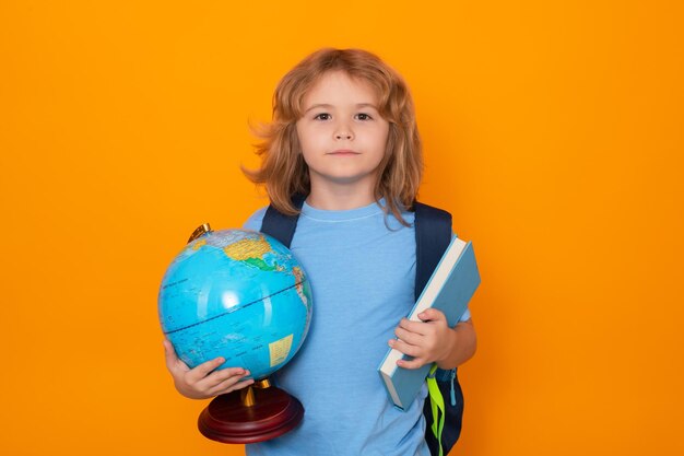 School kids isolated portrait of cute child school boy school and education kids concept clever school boy on yellow studio background