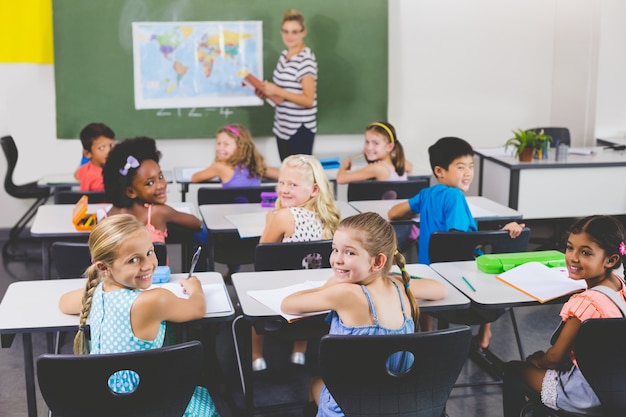 School kids smiling during geography class