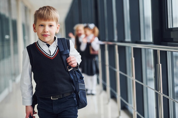 School kids in uniform together in corridor Conception of education