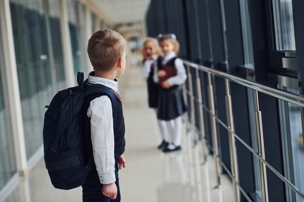 School kids in uniform together in corridor Conception of education