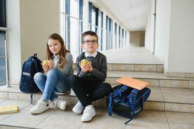 School kids in uniform together in corridor Conception of education