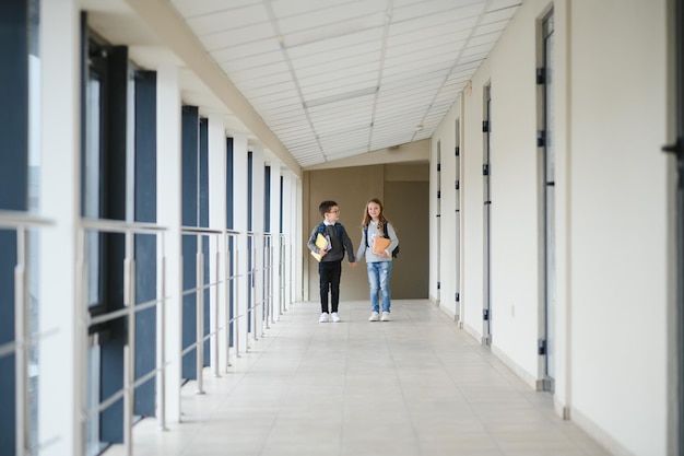 School kids in uniform together in corridor Conception of education