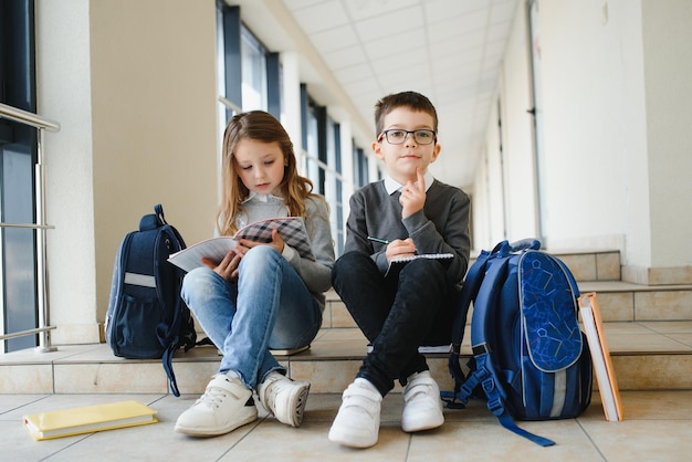 School kids with books together in corridor Conception of education