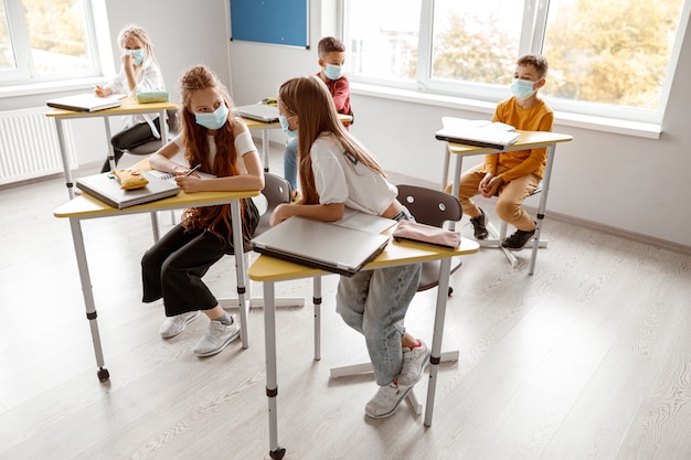 School kids with notebooks enjoying of study together