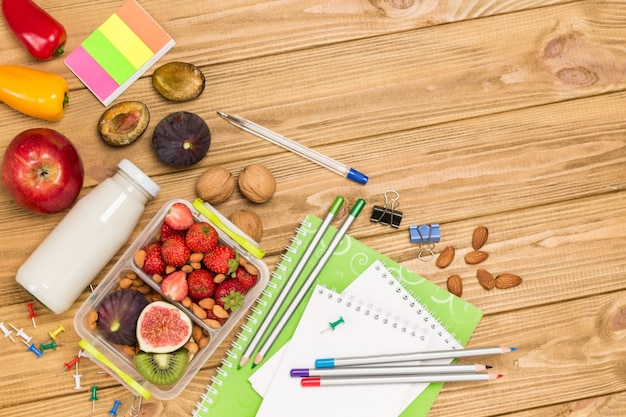 School lunch box with tasty food and stationery