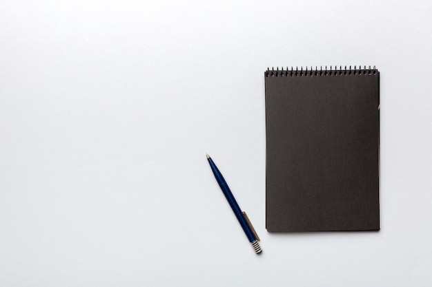 School notebook on a colored background spiral black notepad on a table Top view