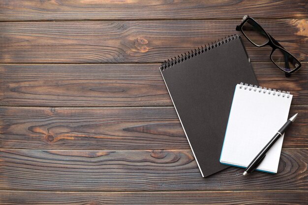 School notebook on a colored background spiral black notepad on a table Top view