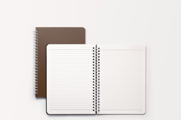 School notebook on a white background, spiral notepad on a table. flatlay