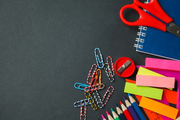 School and office supplies on dark background. Top view with copy space