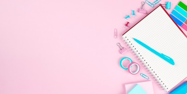 School office supplies on pink background