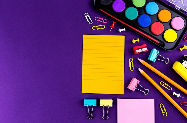 Photo school office supplies stationery on purple