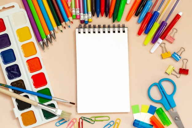 School and office supplies with empty notepad on table. 