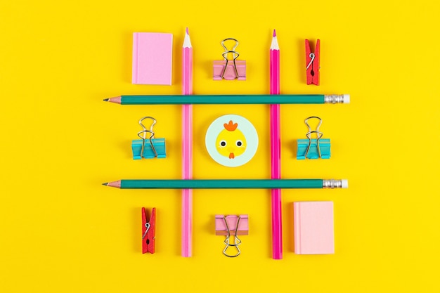 School pencils on yellow surface with school supplies