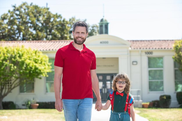 School son boy going to school with father